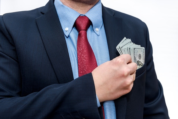 Businessman with dollar banknotes in pocket close up