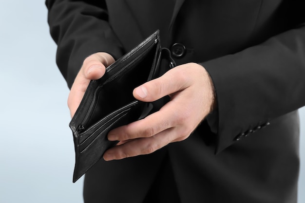 Businessman with empty purse closeup