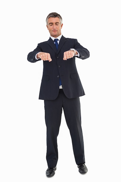 Businessman with eyes closed gesturing