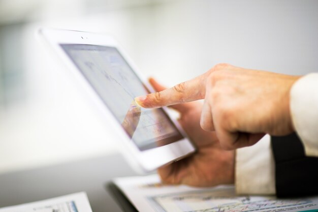 Businessman with finger touching screen of a digital tablet