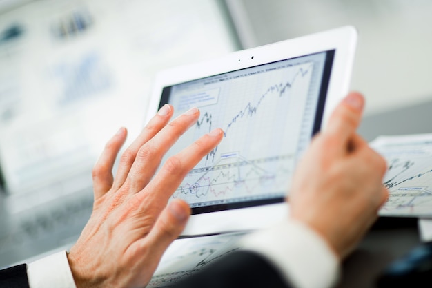 businessman with finger touching screen of a digital tablet