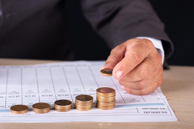 Businessman with graphs and coins on the table. business concept.