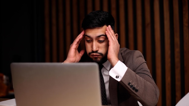 Businessman with hands behind head resting in comfortable office