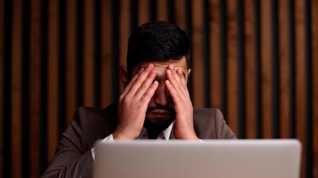 Businessman with hands behind head resting in comfortable office