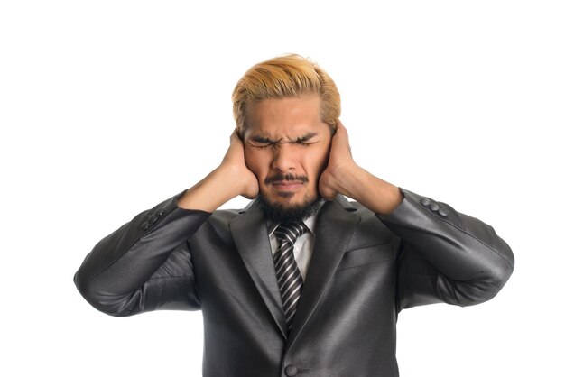 Businessman with headache over white background