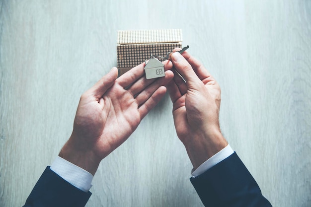 Businessman with house model and key