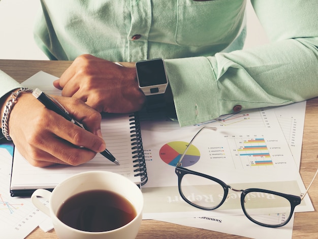 Businessman, with laptop and document working plan  on  wooden table.