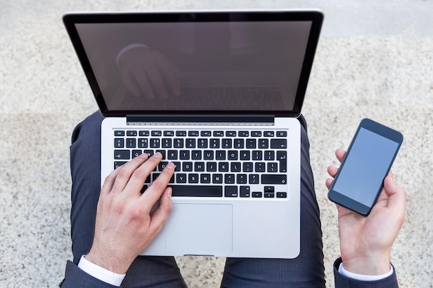 Businessman with laptop and phone