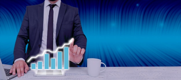 Businessman with laptop and pointing with two fingers data on\
graphs in abstract design man in suit showing chart presentations\
and important data in a meeting