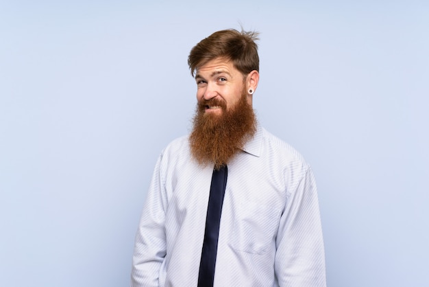 Businessman with long beard having doubts and with confused face expression