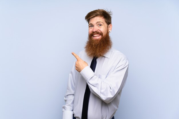 Businessman with long beard over isolated background pointing finger to the side