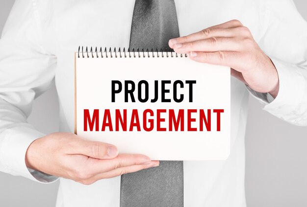 Businessman with notebook with text Project Management