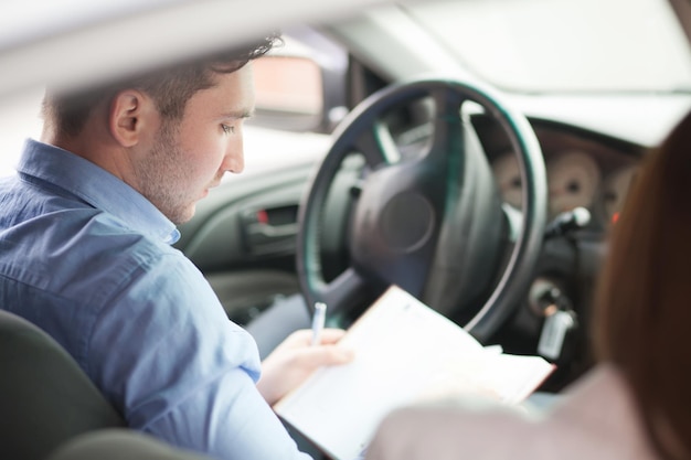 Businessman with notepad sitting in seat , looking out of window, thinking, side view