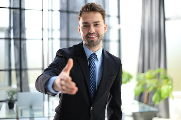 businessman with an open hand ready to seal a deal