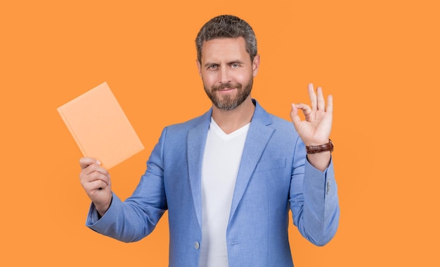 Businessman with planner in jacket ok studio shot of businessman holding planner