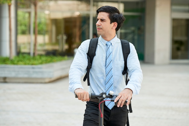 Businessman with scooter outdoors