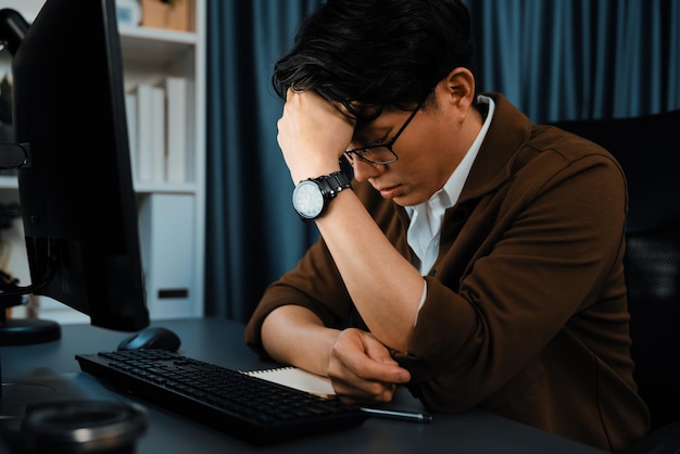 Businessman with stress working pc waiting email from customer infobahn