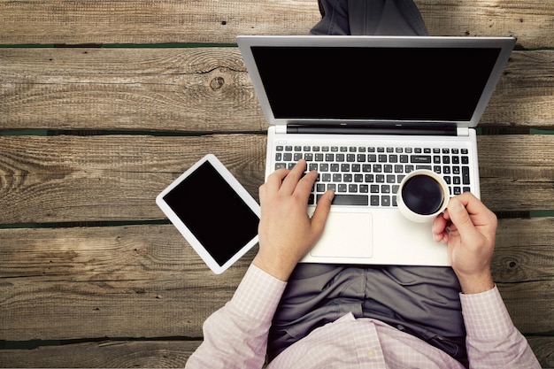 Businessman with  table pc,laptop and coffee