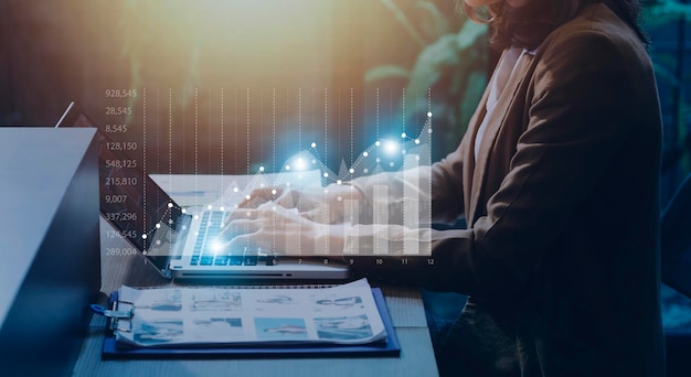 Businessman with a tablet in his hand and touching on the\
screen that shows a business graph the concept of starting a new\
business that goes better