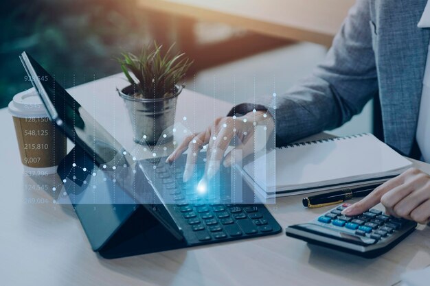 Businessman with a tablet in his hand and touching on the
screen that shows a business graph the concept of starting a new
business that goes better