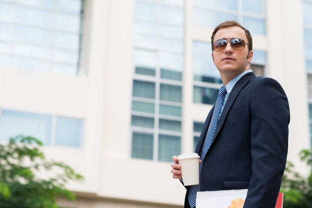 Businessman with take-out coffee