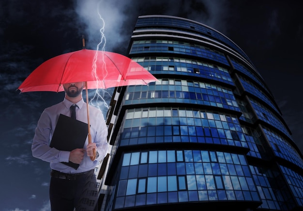 Businessman with umbrella in city center Insurance concept