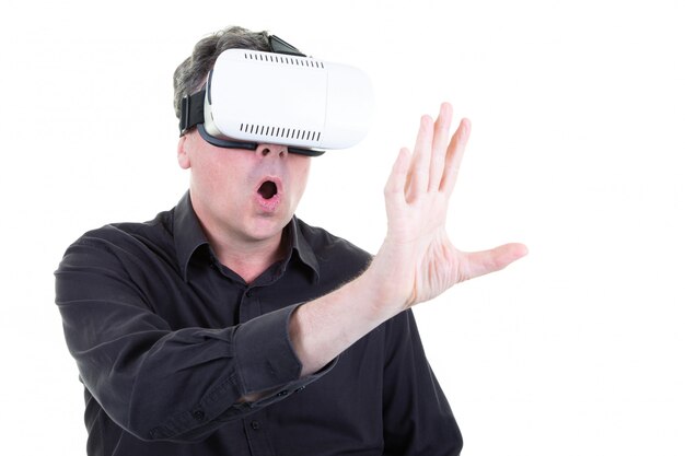 Businessman with a VR headset on head in virtual reality goggles and gestures