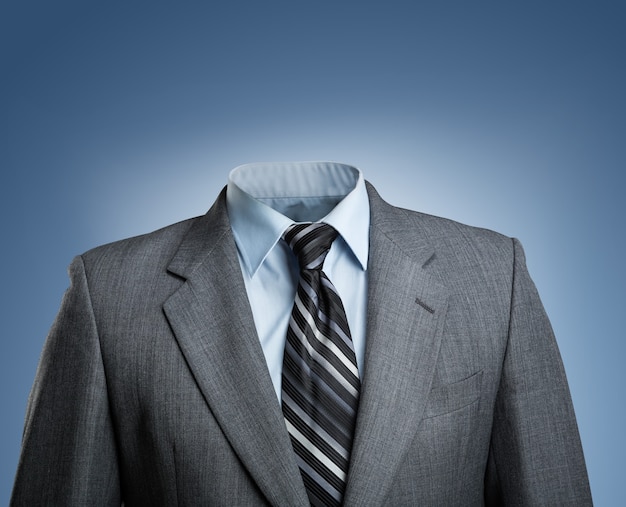 Businessman without head stands over blue background