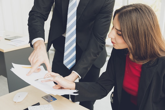 Businessman and woman are discussing informations.