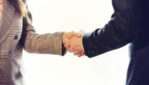 Businessman and woman shake hands as hello in office closeup Friend welcome introduction greet or thanks gesture product advertisement partnership approval arm strike a bargain on deal concept