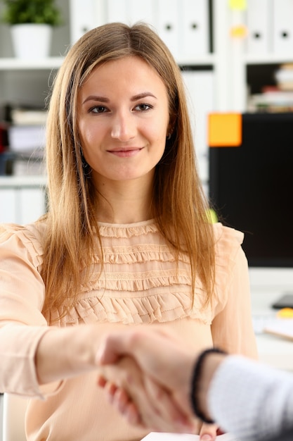 Businessman and woman shake hands as hello