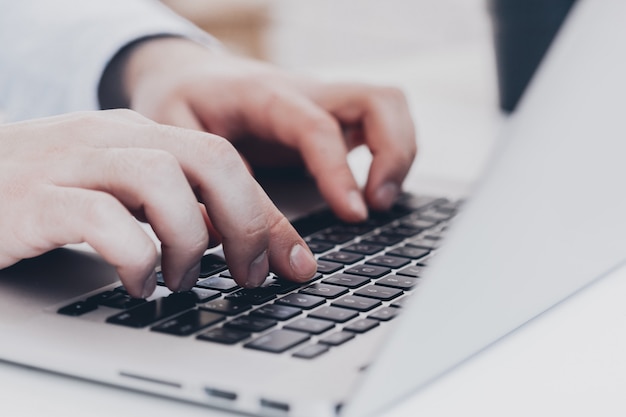 Businessman at work. Close-up top view of man working on laptop 