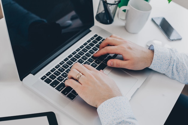 Businessman at work. Close-up top view of man working on laptop 