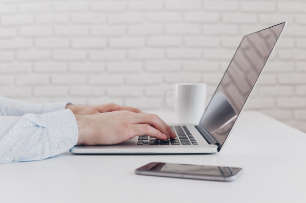 Businessman at work. Close-up top view of man working on laptop 