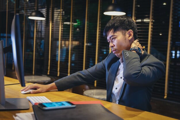 businessman at work suffering from neck pain