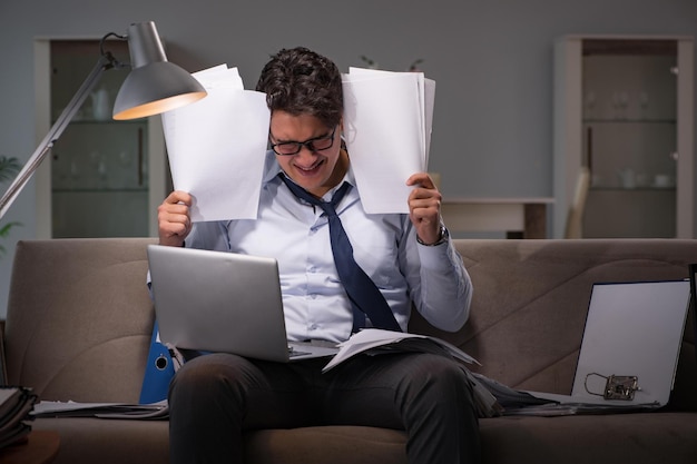 Businessman workaholic working late at home