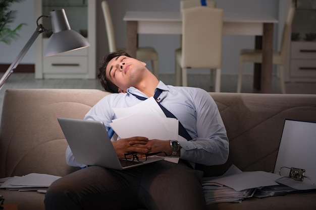 Businessman workaholic working late at home