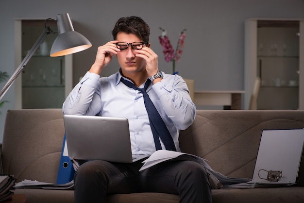 Businessman workaholic working late at home