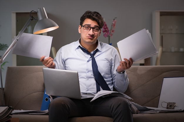 Businessman workaholic working late at home