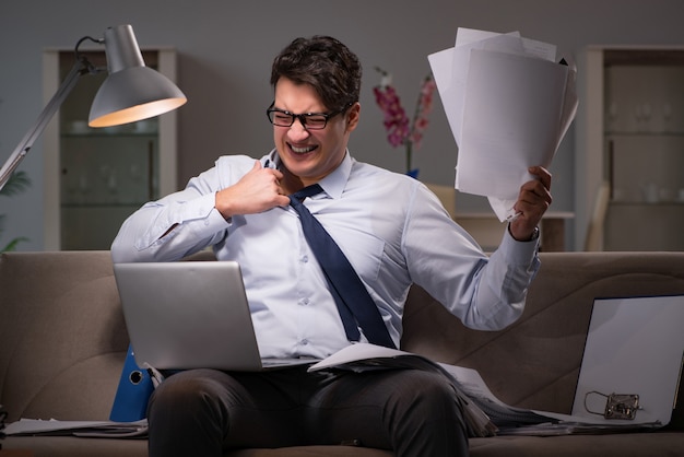 Businessman workaholic working late at home