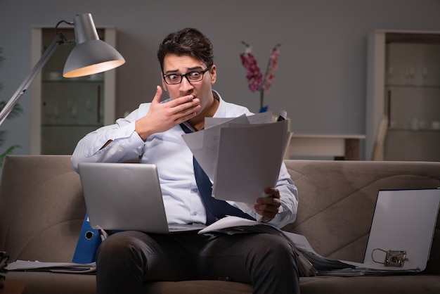 Businessman workaholic working late at home