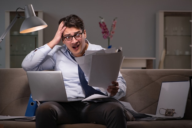 Businessman workaholic working late at home