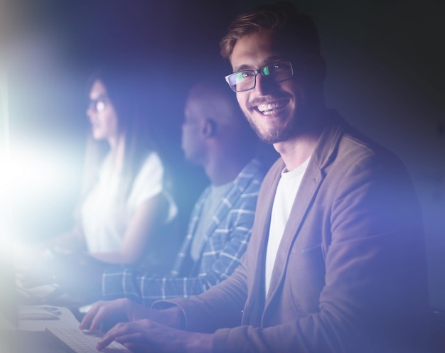 Businessman working on the computer in the office at night