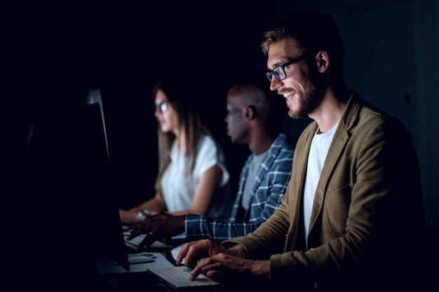 businessman working on the computer in the office at nightthe concept of overtime
