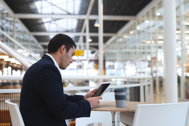 Businessman working on digital tablet at table in a modern office