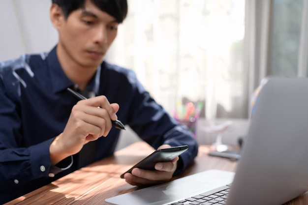 Businessman working in front of a notebook computer at a desk