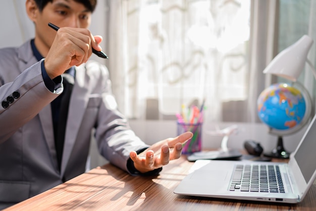 Businessman working in front of a notebook computer at a desk