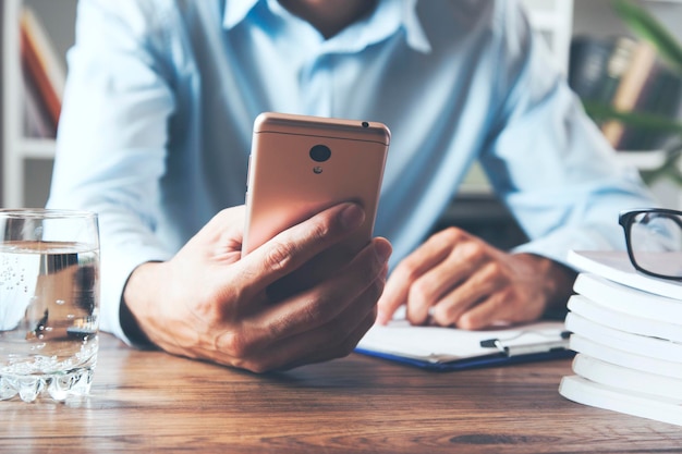 Businessman working hand phone and document