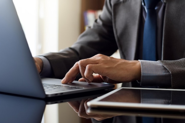 Businessman working on laptop computer at office