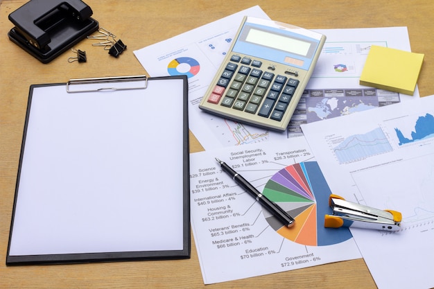 Businessman working on a laptop at office desk with paperwork 